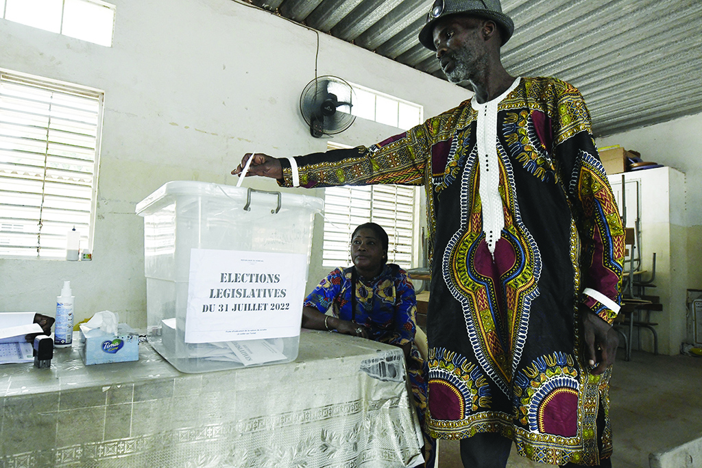 DAKAR, Senegal: A Senegalese voter casts his ballot in Dakar on July 31, 2022 during the July 2022 legislative elections in Senegal. - AFP