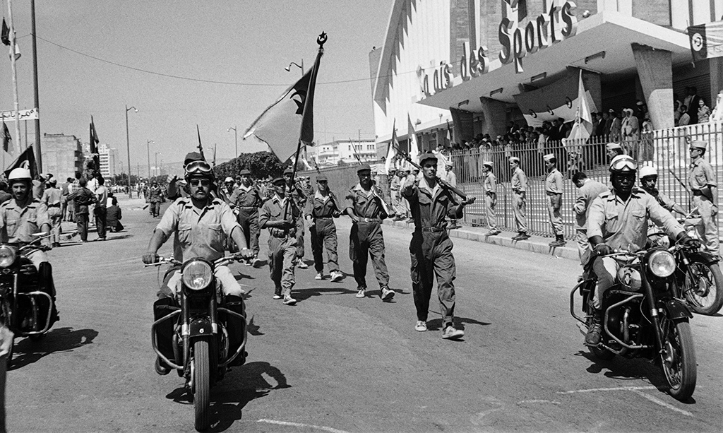 ORAN, Algeria: File photo taken on July 3, 1962, Algerian troops of the National Liberation Army (ALN) parade in front of the Palais de Sports in Oran, during a ceremony celebrating Algeria's independence. - AFP
