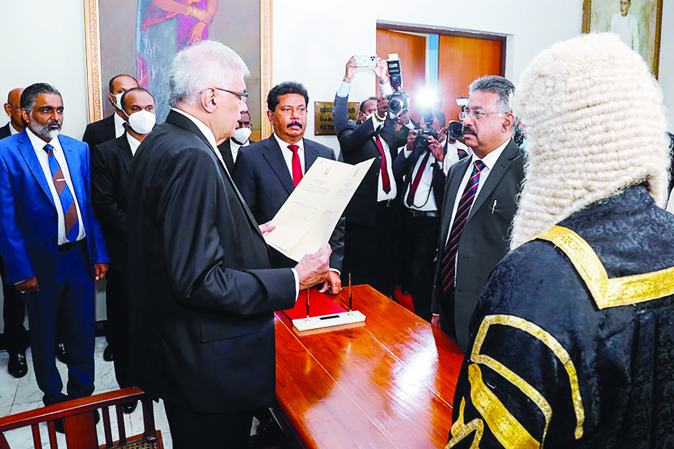 COLOMBO: President-elect Ranil Wickremesinghe (front R) swearing-in as Sri Lanka's President at the parliament in Colombo. Sri Lanka's six-time prime minister Ranil Wickremesinghe was sworn in as president. – AFP