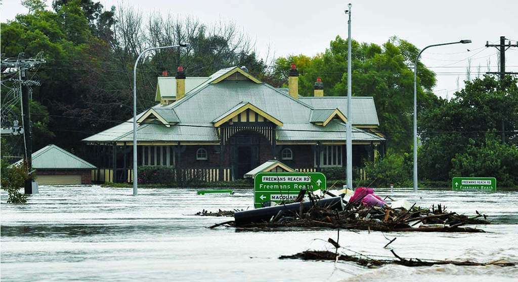 SYDNEY: Flooded buildings are pictured next to the old Windsor Bridge along the overflowing Hawkesbury River in the northwestern Sydney suburb of Windsor on July 4, 2022. – AFP
