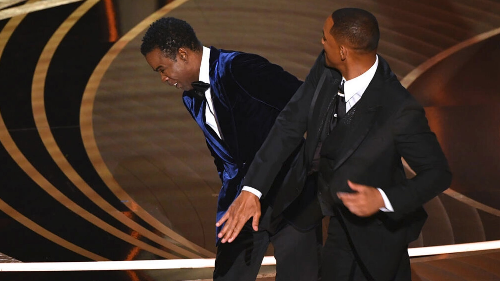 US actor Will Smith (right) approaches US actor Chris Rock, and slaps him onstage, during the 94th Oscars at the Dolby Theatre in Hollywood, California