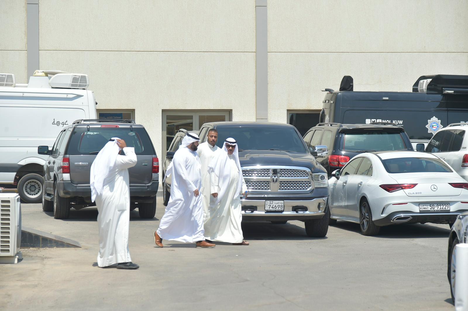 KUWAIT: Former MP Marzouq Al-Khalifa (right) is escorted after he turned himself in after submitting his papers to run for parliament on August 30, 2022. -- Photo by Yasser Al-Zayyat