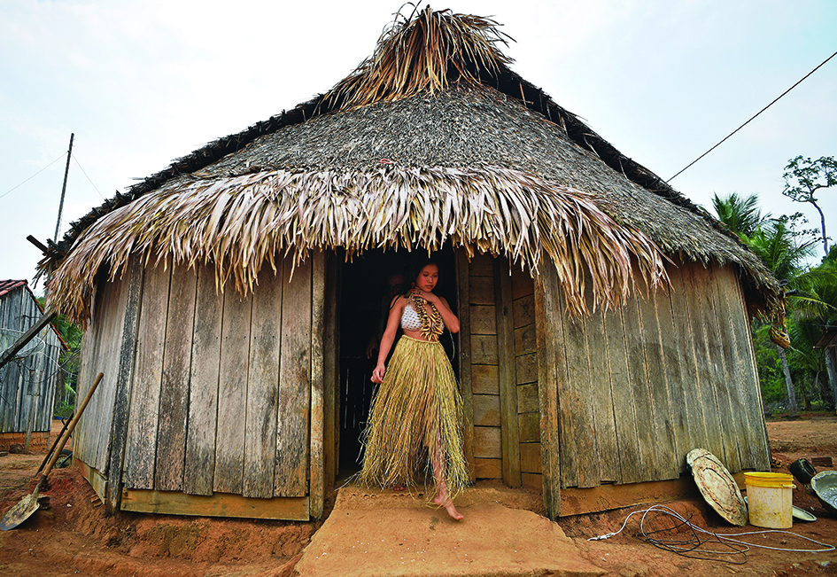 In this file photo a young woman from the Uru Eu Wau Wau tribe gets out from a straw-thatched hut in the tribe's reserve in the Amazon, south of Porto Velho, Brazil. – AFP photos
