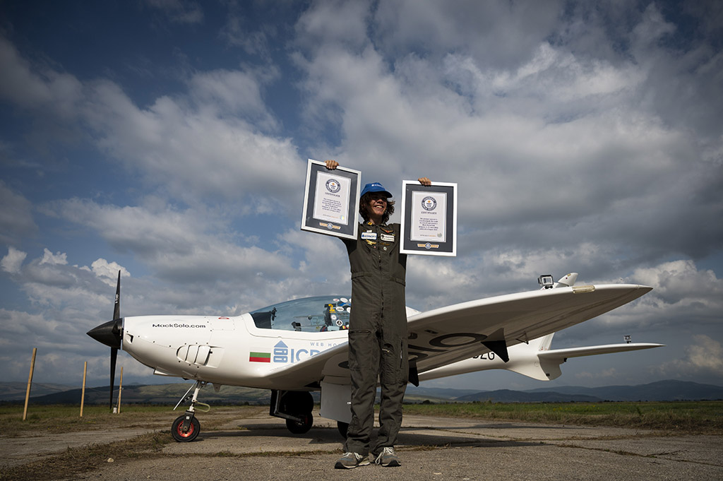 Mack Rutherford, 17, the youngest person to fly solo around the world, poses for photographers with the Guiness World Record certificates, after landing at Sofia West airport near Radomir.- AFP photos
