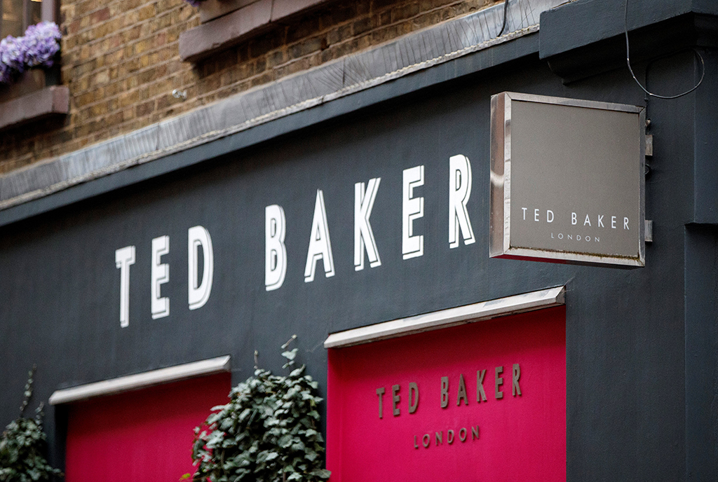 In this file photo a customer carries a Ted Baker-branded shopping bag after leaving a store in London.