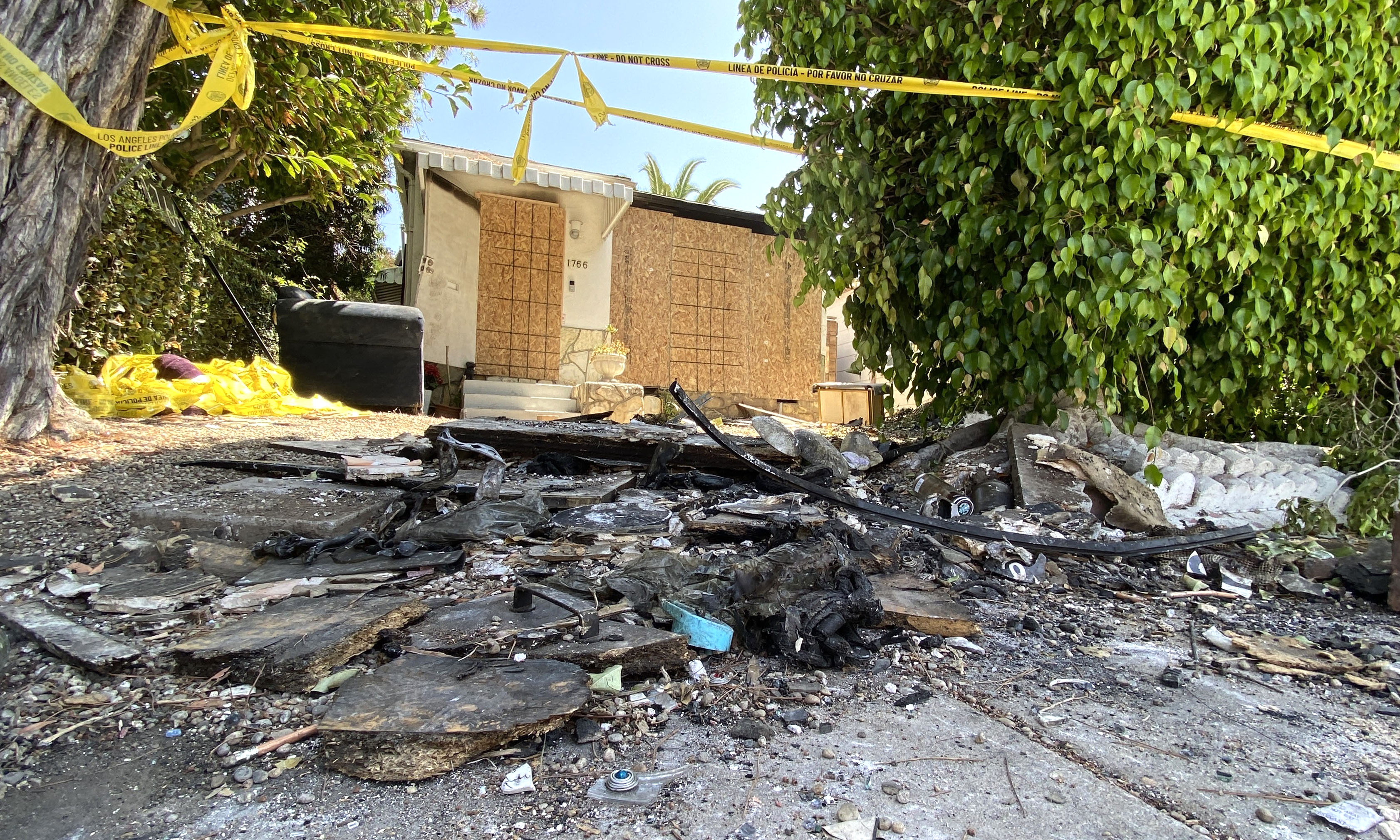 Charred debris and caution tape are seen at the site where US actress Anne Heche crashed into a home in Mar Vista, California.