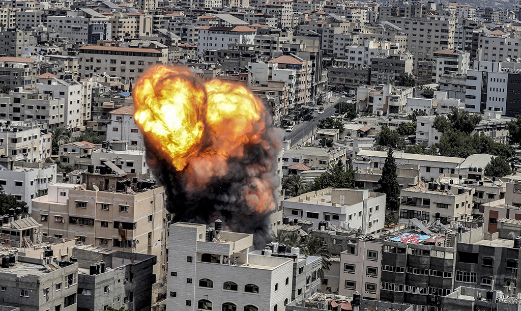 GAZA CITY: A fireball erupts as a result of an Israeli air strike on a building in Gaza City on August 6, 2022. - AFP