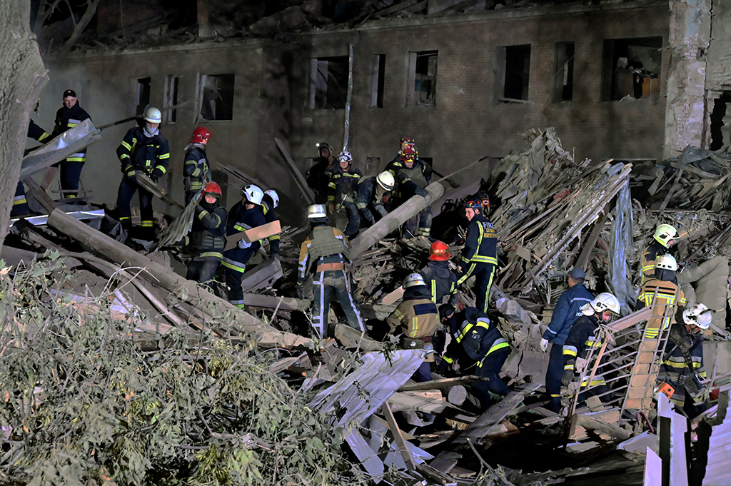 KHARKIV, Ukraine: Rescue workers inspect the site of a destroyed hostel as a result of a missile strike in the second largest Ukrainian city of Kharkiv. - AFP