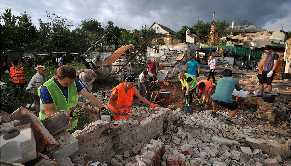 CHERNIGIV, Ukraine: Volunteers clear the rubble of a house destroyed as a result of the shelling in the city of Chernihiv. - AFP