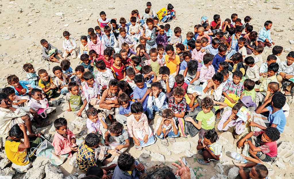 HODEIDAH, Yemen: Children attend classes outdoors amidst the rubble of their destroyed school on the first day of the new academic year in Yemen's war-torn western province of Hodeida. - AFP