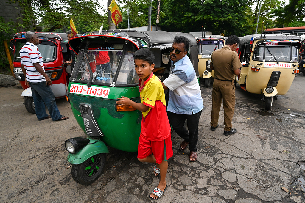 COLOMBO: Motorists queue up along a street to buy fuel from Lanka IOC fuel station in Colombo on August 1, 2022. - AFP
