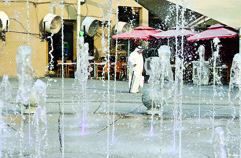 KUWAIT: A man walks past a fountain during a hot day in Kuwait City recently. Kuwait witnessed very hot weather earlier this week, with temperatures exceeding 50 degrees Celsius in some areas. - Xinhua