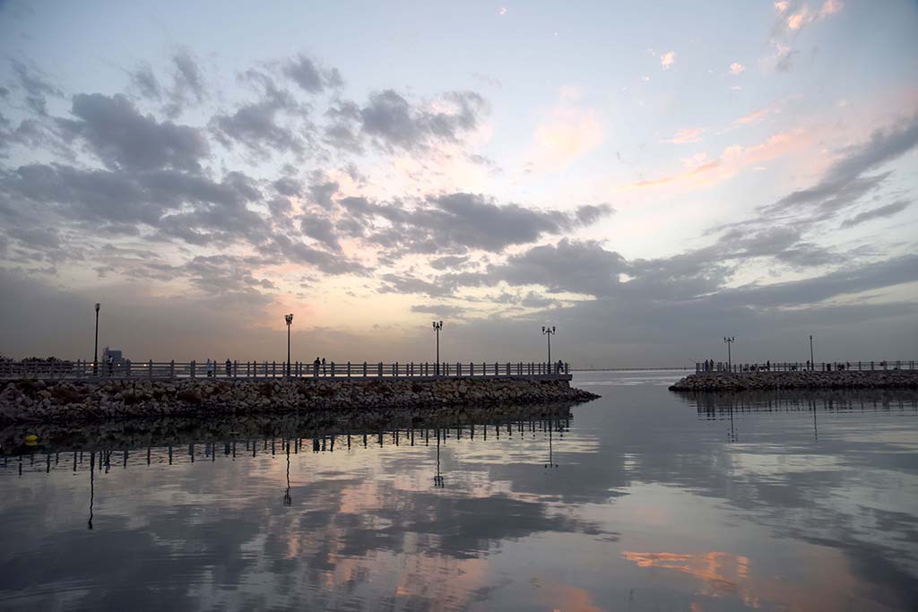 KUWAIT: People relax on a pier at sunset. – Photo by Fouad Al-Shaikh