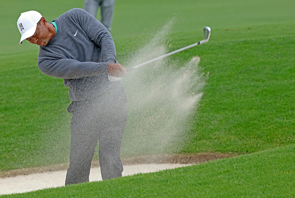 LIMERICK: US golfer Tiger Woods plays out of a bunker on the fifth fairway on the second day of the JP McManus Pro-Am golf tournament at the The Golf Course at Adare Manor in Limerick, south-west Ireland.- AFP