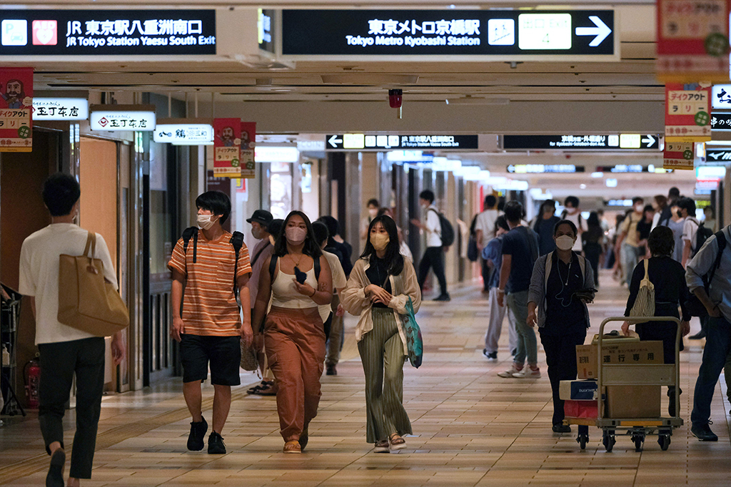 TOKYO: People stroll in an underground shopping mall in Tokyo on August 15, 2022. Japan's economy expanded in the three months to June, official data showed on August 15, after the government lifted COVID-19 curbs on businesses. - AFP