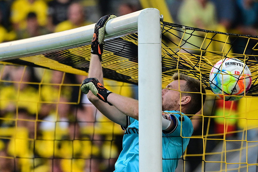 DORTMUND: The ball ends up on the roof of Leverkusen’s Finnish goalkeeper Lukas Hradecky’s goal during the German first division Bundesliga football match between BVB Borussia Dortmund and Bayer 04 Leverkusen in Dortmund, western Germany on August 6, 2022.- AFP