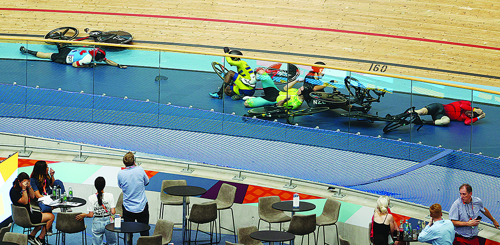 LONDON: Riders lie on the track following a massive crash during the men's 15km scratch race qualifying round cycling event on day three of the Commonwealth Games, at the Lee Valley VeloPark in east London, on July 31, 2022. - AFP