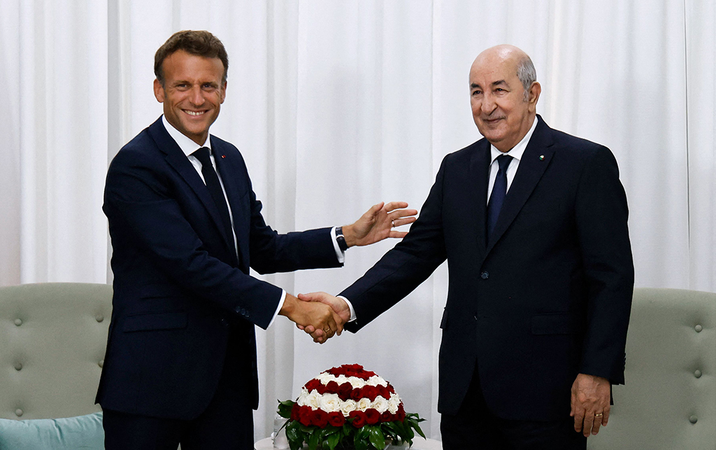 ALGIERS: French President Emmanuel Macron shakes hands with Algeria's President Abdelmadjid Tebboune prior to their bilateral meeting at the presidential palace on August 25, 2022. - AFP