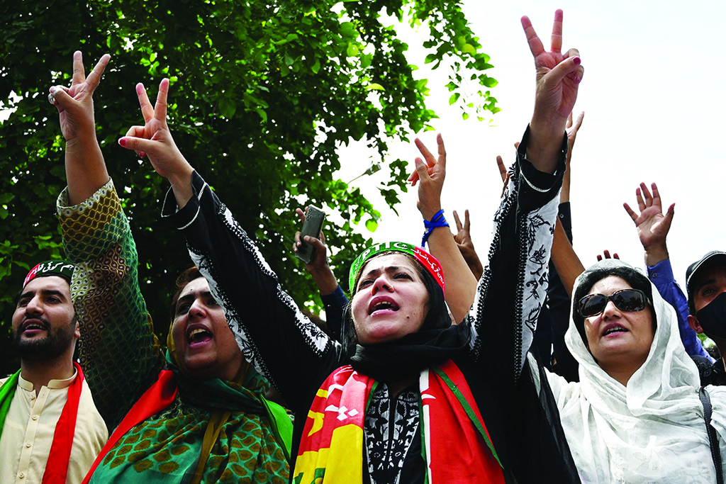 ISLAMABAD: Supporters of Pakistan's former prime minister Imran Khan shout slogans as they gather outside his residence on Aug 22, 2022. - AFP