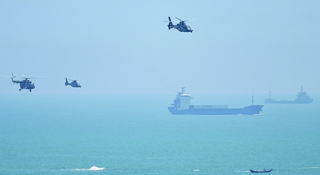 PINGTAN: Chinese military helicopters fly past Pingtan island, one of mainland China's closest point from Taiwan, in Fujian province on August 4, 2022.- AFP