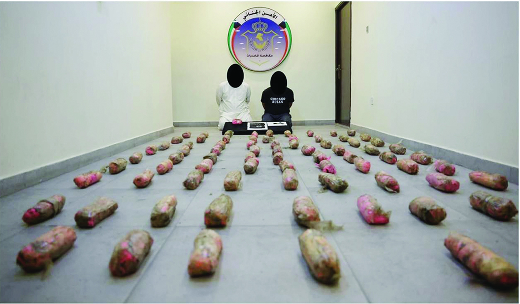 KUWAIT: The suspects, drugs, weapons and cash that were seized.