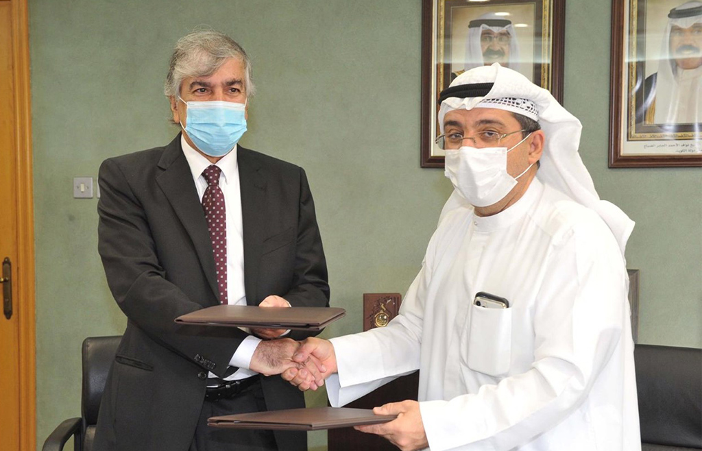 KUWAIT: MOH Undersecretary Dr Mustafa Redha (right) and PAAET deputy general manager Dr Jassem Al-Ansari shake hands after signing the agreement. – KUNA photos