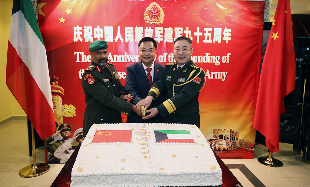 KUWAIT: (From left) Maj Gen Khaled Al-Obaidi, Chinese Ambassador to Kuwait Zhang Jianwei, and Defense Attache of the Chinese Embassy Senior Colonel Xue Chuanlai cut the cake during the ceremony. - Photo by Yasser Al-Zayyat