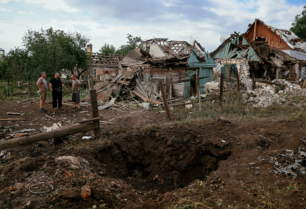 KRAMATORSK, Ukraine: Local residents stand next to the destroyed buildings following a rocket attack in the town of Kramatorsk in Donetsk region, amid the Russian military invasion of Ukraine.— AFP