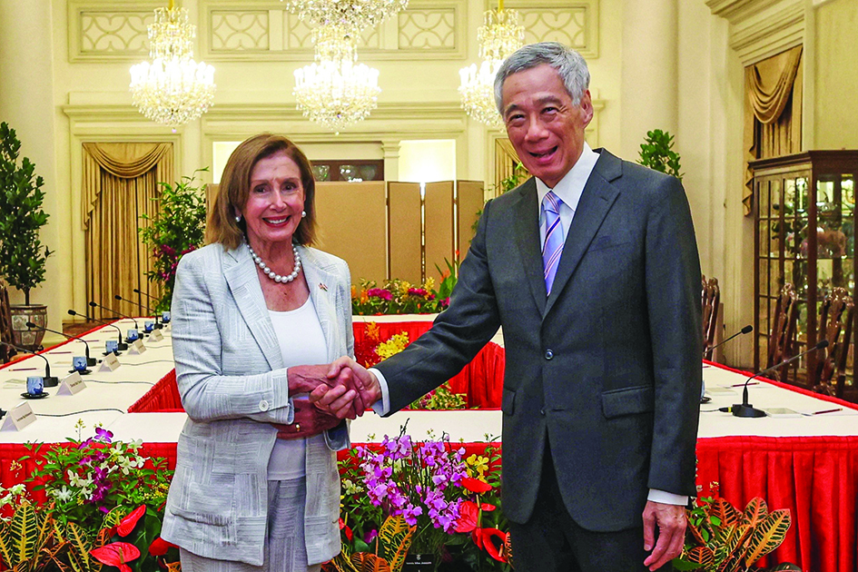 SINGAPORE: Singapore's Prime Minister Lee Hsien Loong (R) shaking hands with US Speaker of the House Nancy Pelosi at the Istana Presidential Palace in Singapore during a visit to the Asia-Pacific region.- AFP