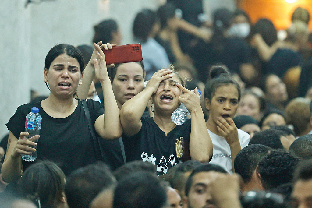 CAIRO, Egypt: Egyptian mourners react during the funeral of victims killed in Cairo Coptic church fire, at the church of the Blessed Virgin Mary in the Giza Governorate. - AFP