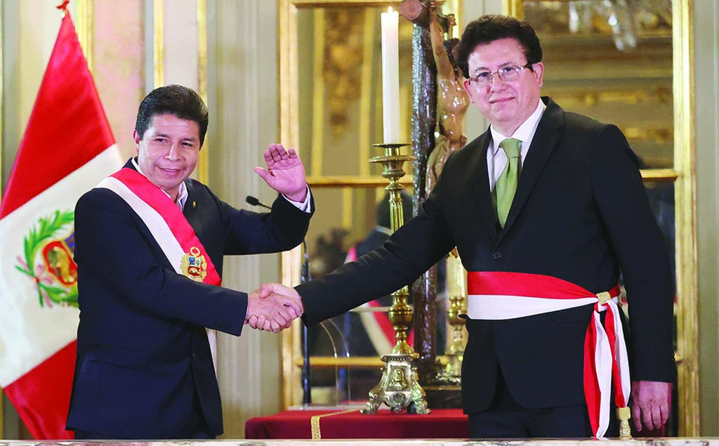 LIMA: Peru's President Pedro Castillo (L) congratulating Miguel Rodriguez, after the latter was sworn in as his Minister of Foreign Affairs in Lima. – AFP