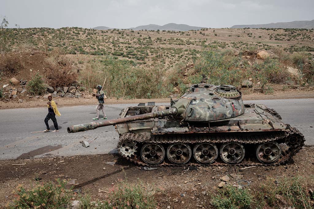 DANSA, Ethiopia: File photo shows local farmers walk next to a tank of alledged Eritrean army that is abandoned along the road in Dansa. Ethiopian authorities accused Tigray rebels of launching a new offensive against federal forces in the country's north, five months after a truce paused the worst of the fighting. – AFP