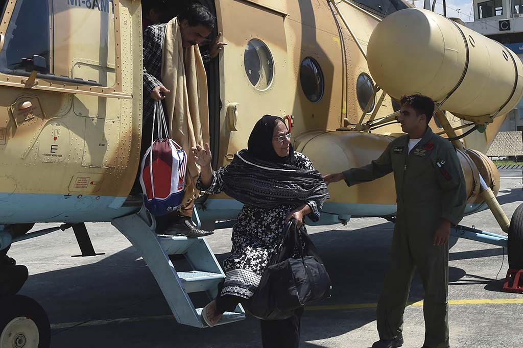 SWAT, Pakistan: Stranded local tourists disembark from a Pakistan's army helicopter after they were rescued by army from the flood-hit tourist areas in Saidu Sharif. – AFP