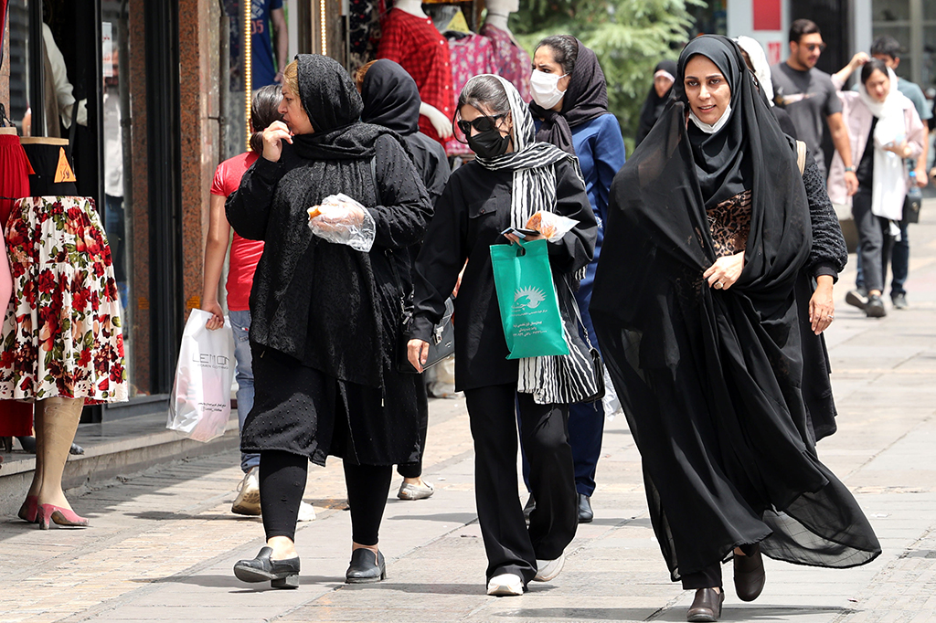 TEHRAN: Iranians walk at Valiasr square in the capital Tehran. Iran's President Ebrahim Raisi came to power a year ago, amid attempts to revive a 2015 nuclear deal between Tehran and world powers. - AFP