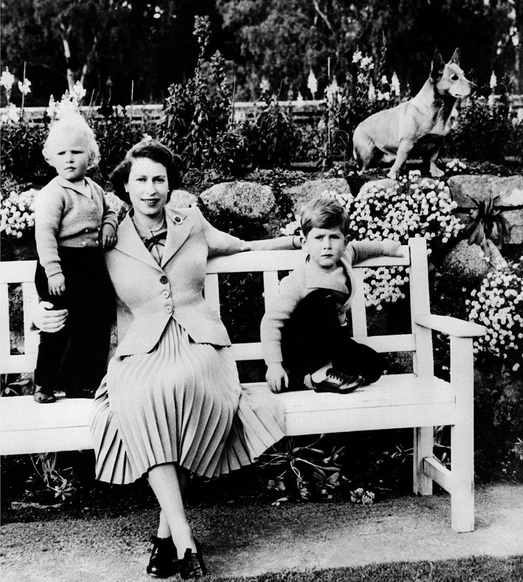 In this undated picture from 1954 the Queen Elizabeth II, poses with her two children Charles (right) and Ann and a corgi in Balmoral.- AFP photos