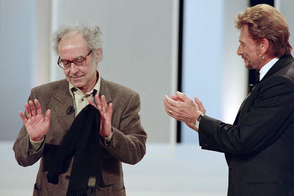 In this file photo taken on February 28, 1998 French singer Johnny Hallyday (right) applauds Franco-Swiss film director Jean-Luc Godard (left) receiving an Honorary César during the 23rd César Awards ceremony at the Théâtre des Champs-Élysées in Paris.— AFP photos