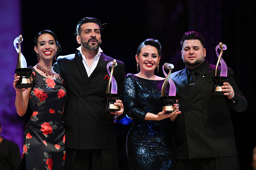 Winners of the Stage Tango Style category Argentine dancers Constanza Vieyto (left) and Ricardo Astrada (second left), pose with winners of the Pista Tango Style category Argentine dancers Cynthia Palacios (second right) and Sebastian Bolivar during the World Tango Championship final in Buenos Aires, Argentina. - AFP