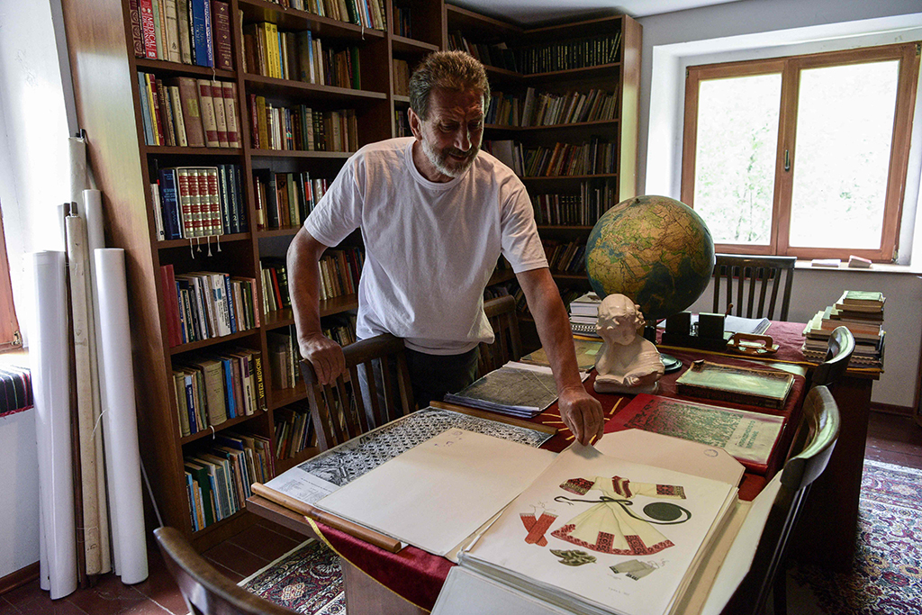 Stevo Stepanovski shows a volume from his library in the village of Babino.
