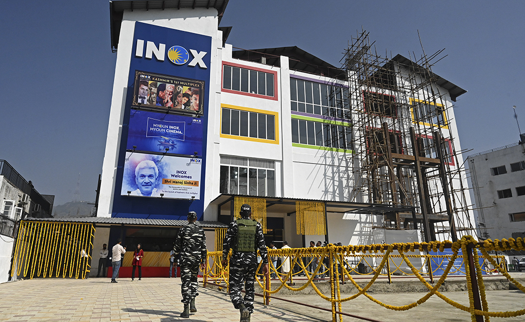 Indian paramilitary troopers walk in front of a multiplex cinema during its inauguration ceremony in Srinagar.— AFP photos 