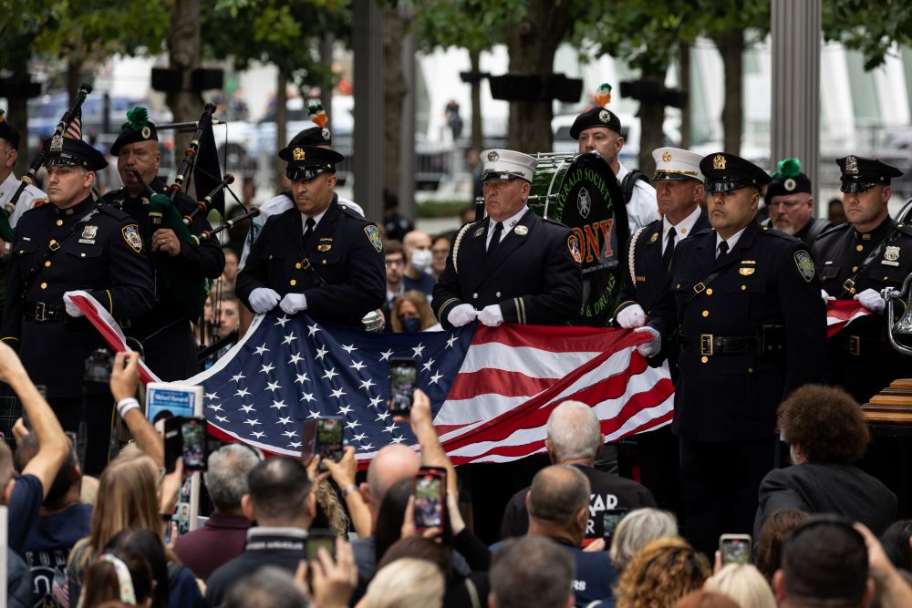 NEW YORK: Members of New York Fire Department raise a US flag at the 9/11 Memorial in New York City on September 11, 2022, on the 21st anniversary of the attacks on the World Trade Center, Pentagon, and Shanksville, Pennsylvania. - AFP