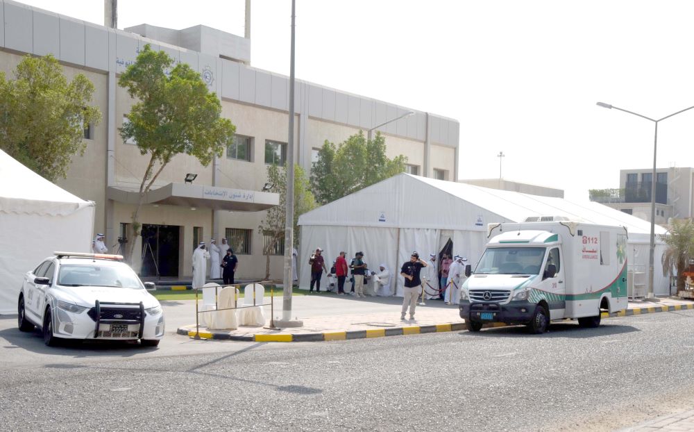 KUWAIT: People stand outside the election registration center. -- Photo by Fouad Al-Shaikh