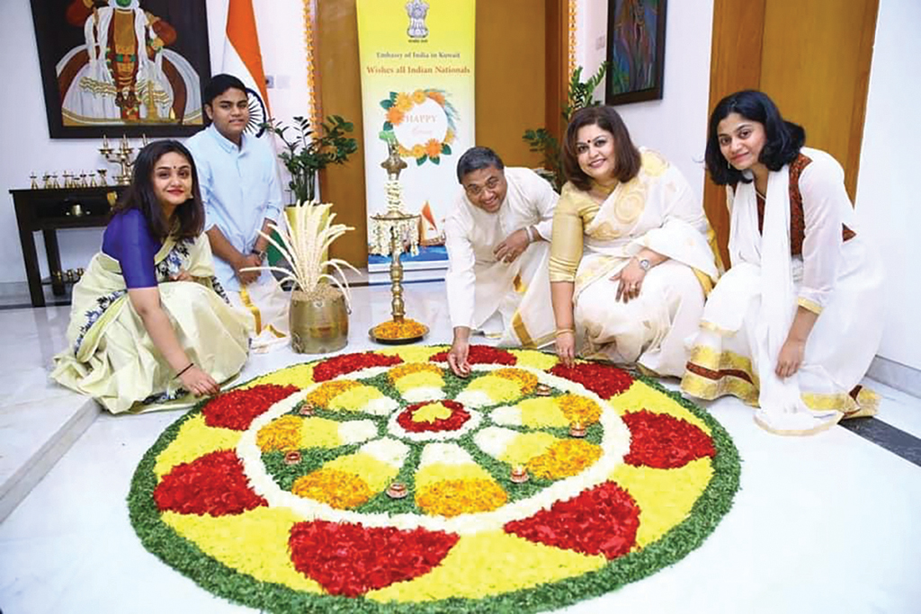 KUWAIT: Indian Ambassador Sibi George laying out a floral carpet (pookalam), with his family on the occasion of Onam at India House in Kuwait.