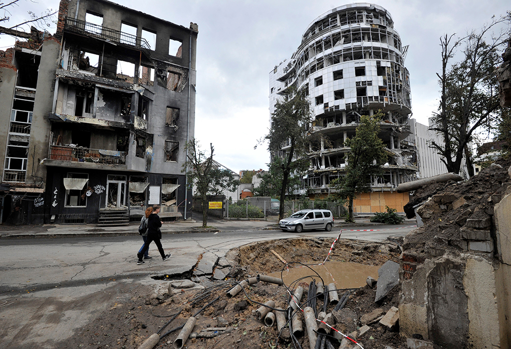 KHARKIV, Ukraine: People walk by a destroyed building following shelling in the center of Kharkiv, amid Russian invasion of Ukraine. – AFP