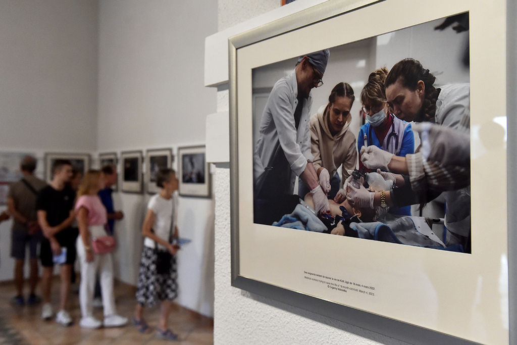 This photograph shows people visiting the ‘Marioupol, Ukraine’ exhibition by Ukrainian photographers Evgeniy Maloletka and Mstyslav Chernov during the 34th edition of the Visa pour l’Image international photojournalism festival in Perpignan, southern France. – AFP