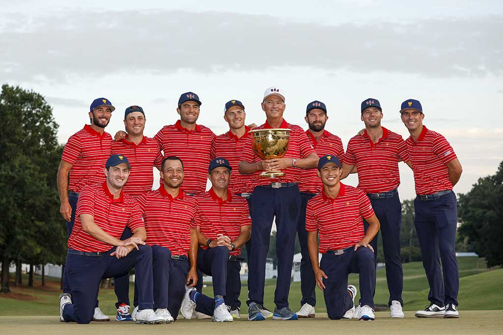 CHARLOTTE: (Back left-right) Tony Finau, Max Homa, Justin Thomas, Scottie Scheffler, Jordan Spieth, Captain Davis Love III, Cameron Young, Sam Burns, Billy Horschel. (Front left-right) Patrick Cantlay, Xander Schauffele, Kevin Kisner and Collin Morikawa of the United States Team pose with the Presidents Cup after defeating the International Team during Sunday singles matches on September 25, 2022.- AFP