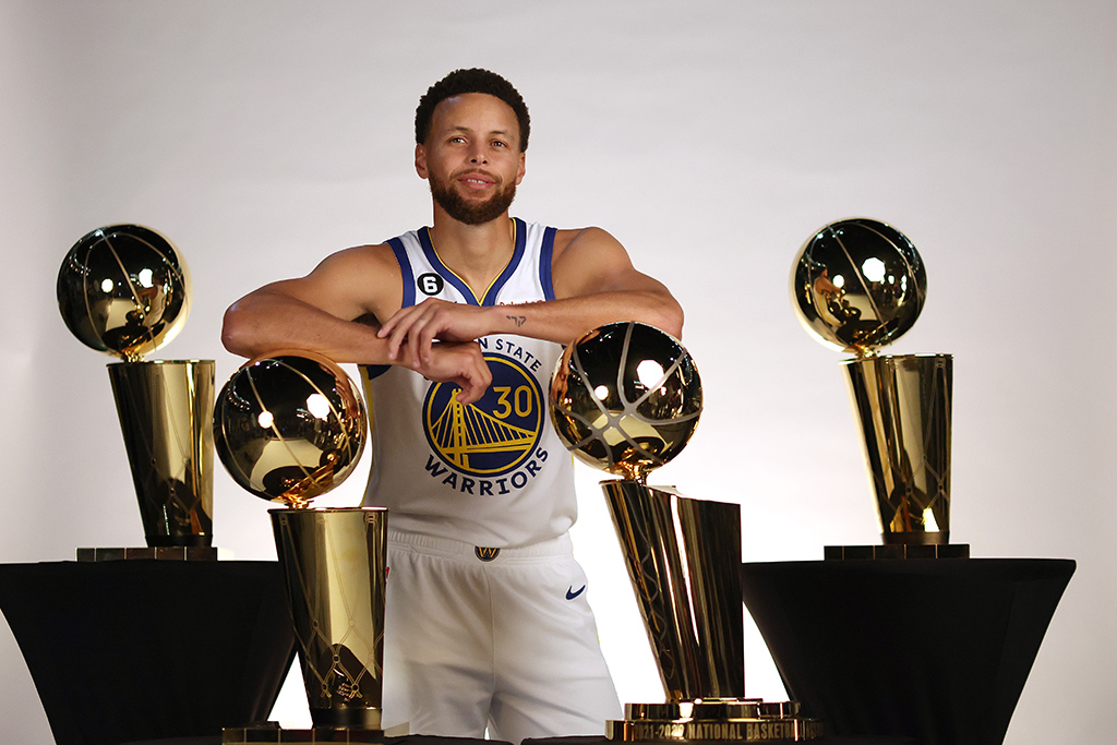 SAN FRANCISCO: Stephen Curry #30 of the Golden State Warriors poses with the four Larry O’Brien Championship Trophies that he has won with the Warriors during the Warriors Media Day in San Francisco, California. - AFP