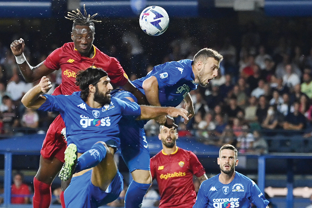 EMPOLI: AS Roma's British forward Tammy Abraham (left) heads the ball past Empoli's Italian defender Sebastiano Luperto (2nd left) and Empoli's Albanian defender Ardian Ismajli (3rd left) during the Italian Serie A football match between Empoli and As Roma on September 12, 2022. - AFP
