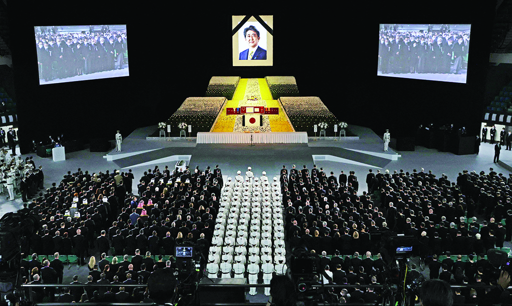 TOKYO: A portrait of Japan's former prime minister Shinzo Abe hangs above the stage during his state funeral in the Nippon Budokan on Sept 27, 2022.  - AFP