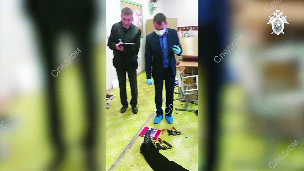IZHEVSK, Russia: This screen grab taken from footage released on Sept 26, 2022 shows investigators working by the body of a gunman in school No88. – AFP