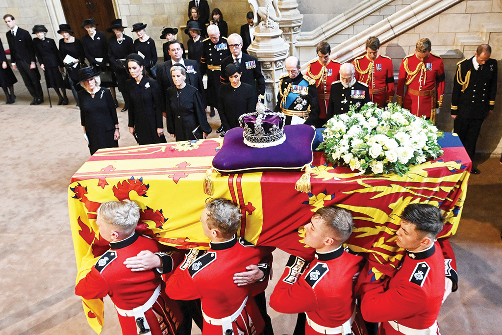 LONDON: Pallbearers carry the coffin of Queen Elizabeth II as they arrive at Westminster Hall at the Palace of Westminster on Sept 14, 2022, where the coffin will lie in state. - AFP